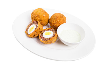 Baked scotch eggs with tartar sauce.