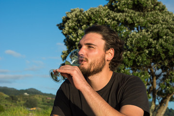 Men enjoying a glass of white wine in the nature