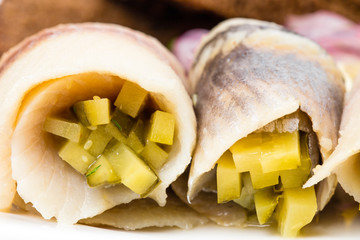 Salted herring fillet with pickles.