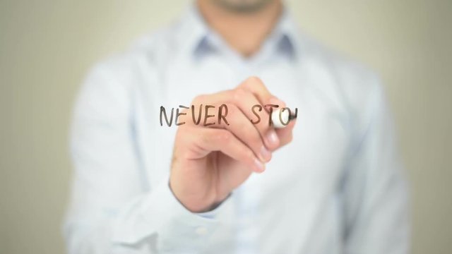 Never Stop Dreaming,  Man writing on transparent screen