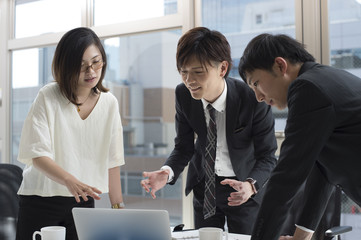 Three businessmen have a new product meeting at the office