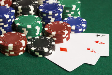 There are a lot of poker chips and three card