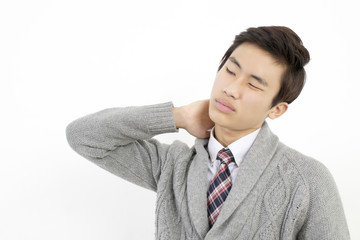 Man with neck and shoulder pain, after long hours of work studying