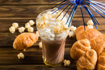 Caramel popcorn with cacao whipped cream and croissants