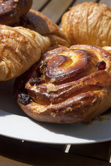 Detail of delicious croissants on a plate ready to be eaten for breakfast outdoors