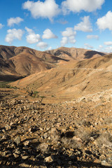 Beautiful volcanic mountains and the road on a mountain slope.  Road from la Pared to Betancuria . Fuerteventura. Canary Islands