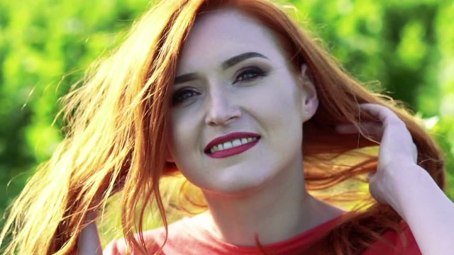Portrait of happy girl in the green wheat field. Slowly