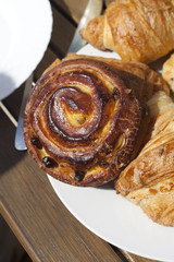 Detail of delicious croissants on a plate ready to be eaten for breakfast outdoors