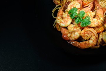 Prawn tomato spagetti on black background