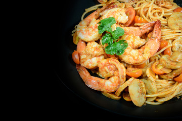 Prawn tomato spagetti on black background