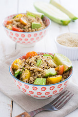 Quinoa salad in bowl on a white wooden table
