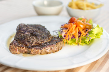 beef steak and vegetables with tomatoes and french fried