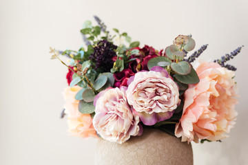 Fresh beautiful flowers in vase over white background