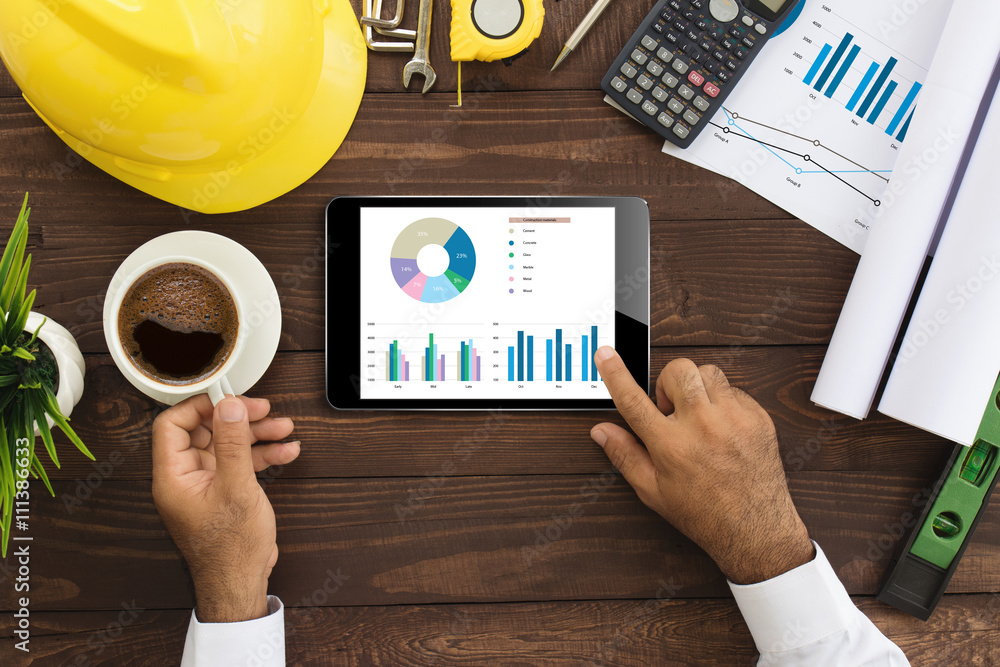 Aufkleber engineer using tablet checking business graph on work table