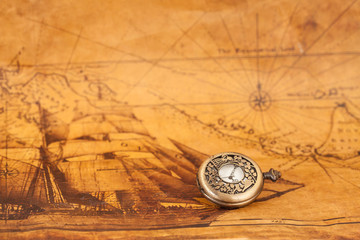 Pocket watch on old map background, vintage style light and tone