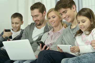 happy family with electronic gadgets