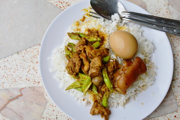 spicy stir fried curry chicken entrails and sweet boiled brown egg on rice