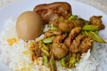 spicy stir fried curry chicken entrails and sweet boiled brown egg on rice