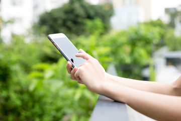 Woman using mobile phone at park