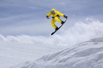 Snowboard rider jumping on mountains. Extreme snowboard freeride sport.