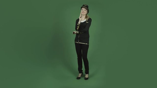 caucasian air hostess isolated on chroma green screen background with fingers crossed