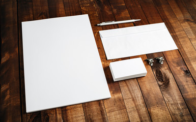 Blank brand template. Photo of blank stationery set on wooden table background. Letterhead, business cards, envelope and pen.
