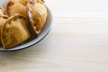 Closeup of typical spanish empanadillas, small meat or tuna fried pies, copyspace