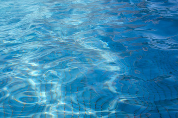 Blue swimming pool rippled water for background or texture