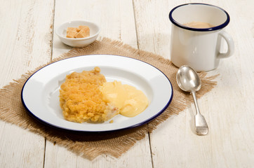 british apple crumble with custard on enamel plate