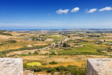 Fototapeta na wymiar Sunny view of surrounding fields from tower of Mdina, Malta.