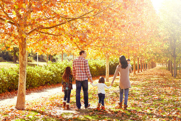 family walking in an autumn park