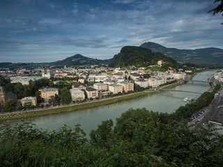 Fototapeta na wymiar A view of the houses standing round the floating river Salzach in Salzburg, 2015