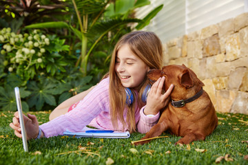 Blond kid girl selfie photo tablet pc and dog