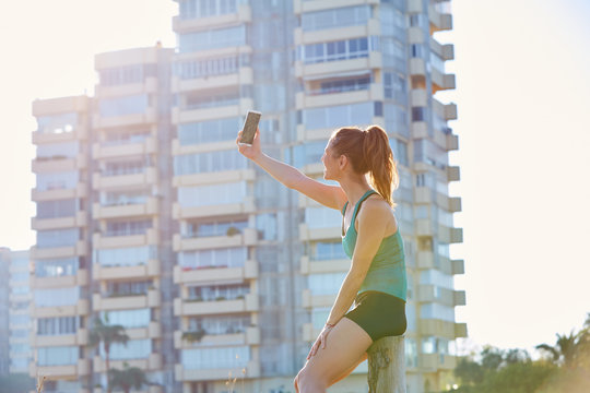 Runner Girl Having A Rest Shooting Selfie