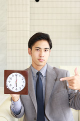 時計を持つ笑顔のビジネスマン