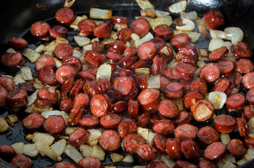Grilled sausages with onions in a pan