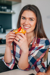 Beautiful young woman eating sweet dessert.