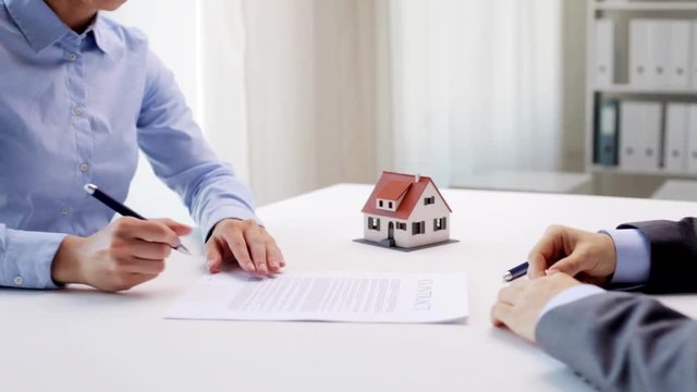 business partners with house keys and contract
