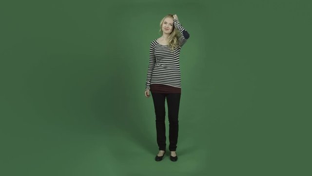caucasian woman isolated on chroma green screen background thinking scratching head