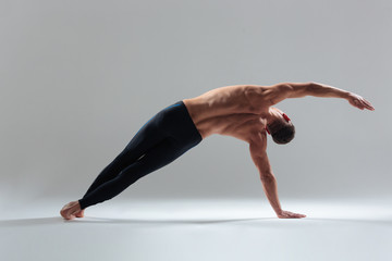 Full length portrait of a fitness man warming up