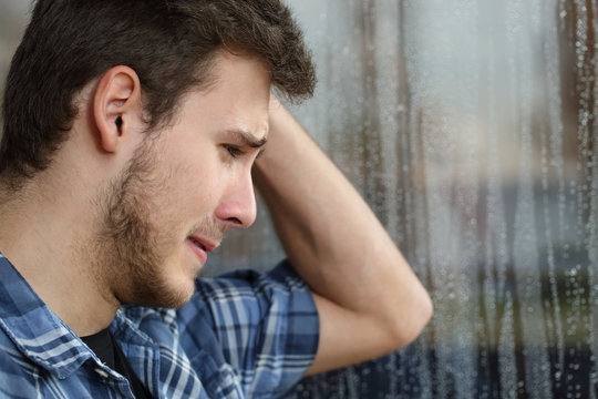 Sad Man Looking Through Window A Rainy Day