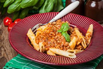 Penne a bolognese on white plate.