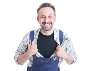 Cheerful attractive mechanic with metallic spanner acting like s