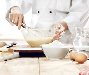 hands in kitchen making cake 