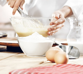 hands in kitchen making cake 