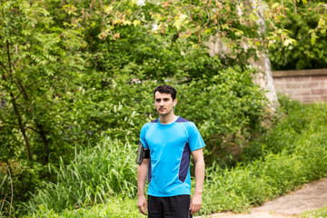 Running workout man with mp3 music player listening to music with mp3 player armband with smart mobile phone.