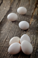 White chicken eggs, on wooden surface