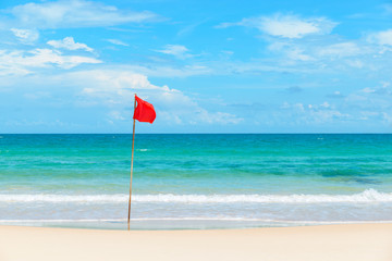 Red flag on tropical beach