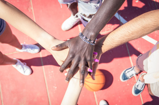Group of multiracial basketball team hands