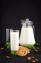 glass of milk with cookies almonds mint